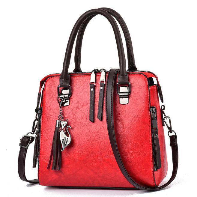 Damen Schultertasche Vintage aus rotem PU-Leder mit Quaste und verstellbarem Schulterriemen.