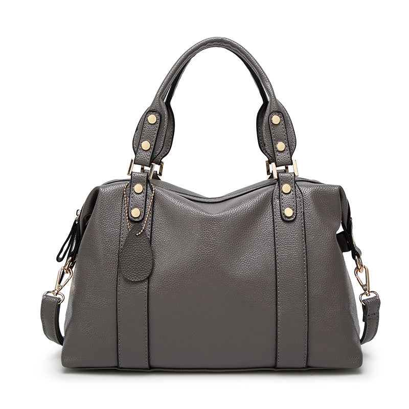 Elegante Damenhandtasche in Dunkelgrau mit Lychee-Struktur, Doppelhenkeln und goldfarbenen Nieten - Vorderansicht