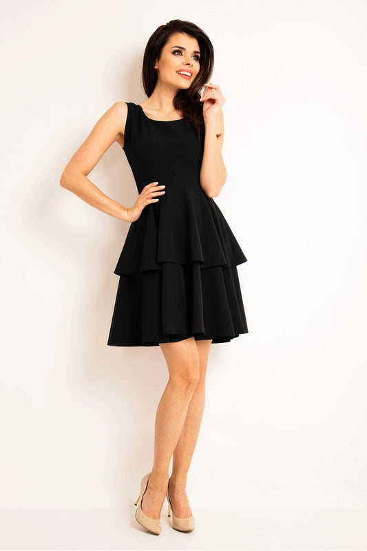 Woman wearing black sleeveless tiered daydress model 80496 with beige heels