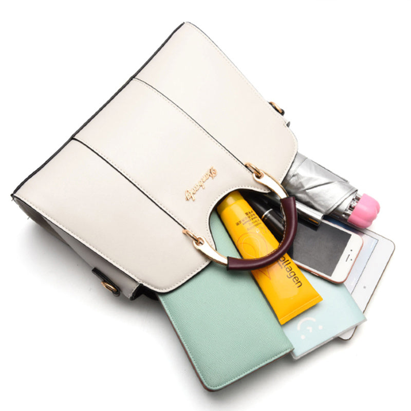 Geöffnete Damen Handtasche mit mehreren Fächern - ideal organisiert mit Handy, Kosmetik und Notizbuch