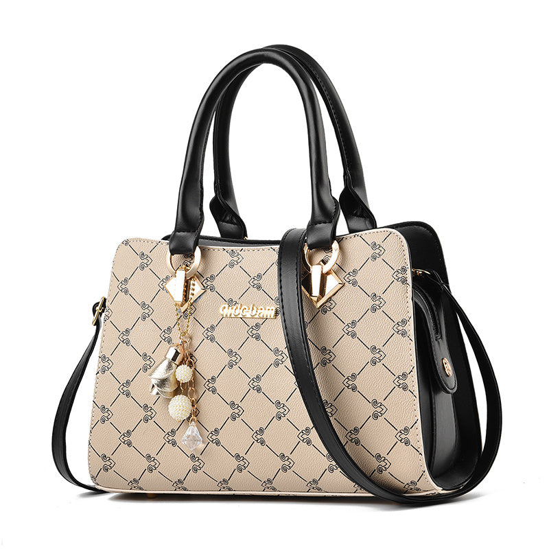 Damen Handtasche mit geometrischem Muster aus PU-Leder, schwarze Henkel und Schulterriemen, stilvolles Design mit Anhänger.
